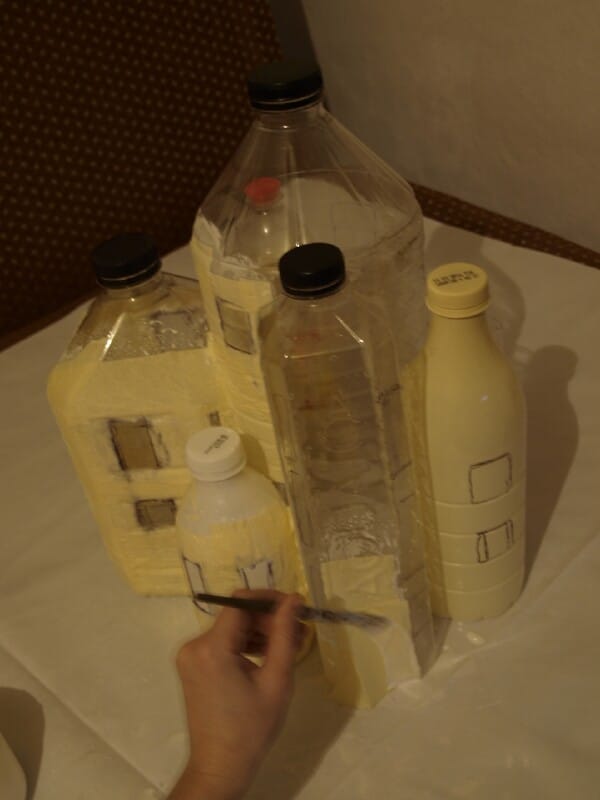 Cover the bottles with glue.