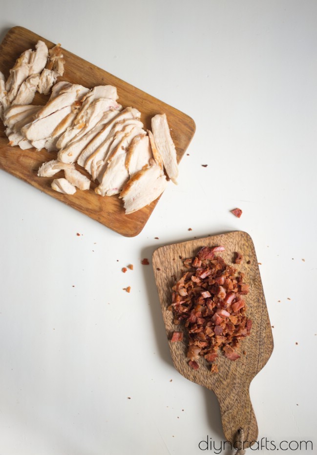 Preparing chicken breasts and bacon.