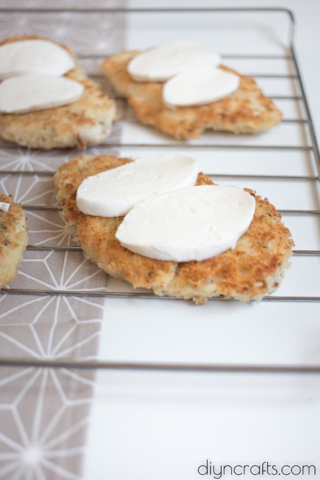 Adding sliced mozzarella.