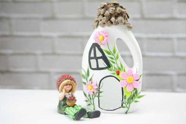 Fairy house jug beside a fairy figurine