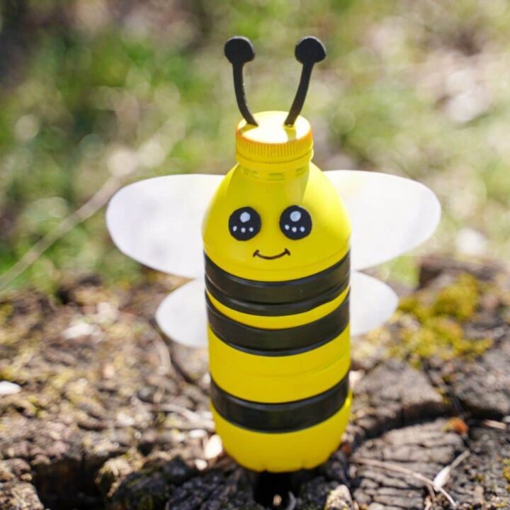 Close-up of a plastic bottle bumblebee bank in progress, showing painted yellow base.