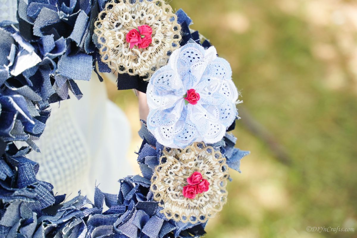 Denim Wreath on Front Door Finished denim rag wreath hanging on a light colored door