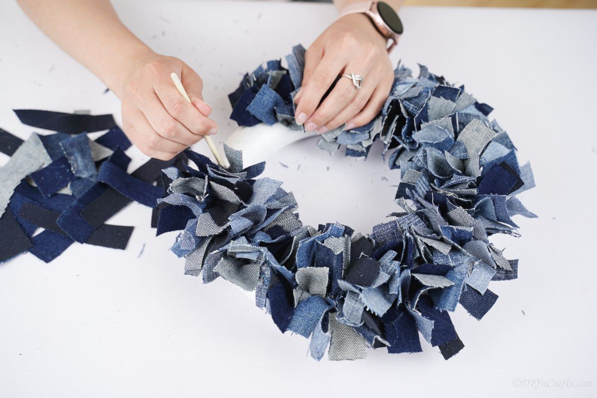 Decorated Denim Wreath Close-up Denim rag wreath decorated with lace and burlap bows, ready for display