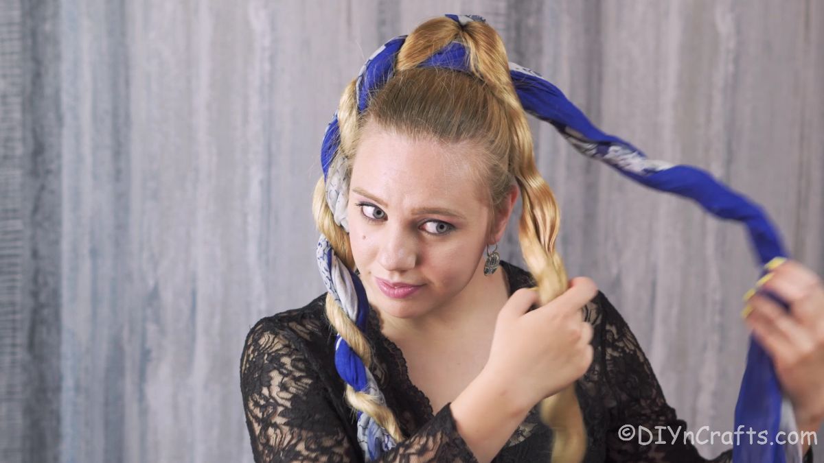 scarf being removed from blonde hair creating curls