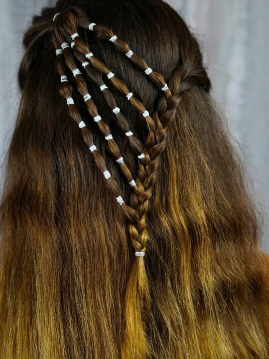 Playful Waterfall Bubble Half-Updo 4 Woman styling hair for waterfall bubble braids